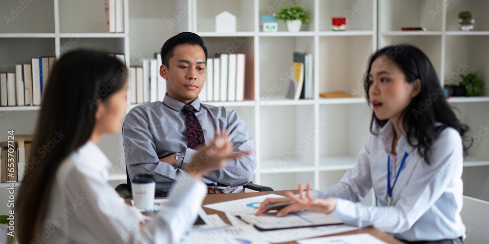 Fototapeta premium Asian young businesspeople are stress while working in meeting room, Tired businessman with headache at office, feeling sick at work