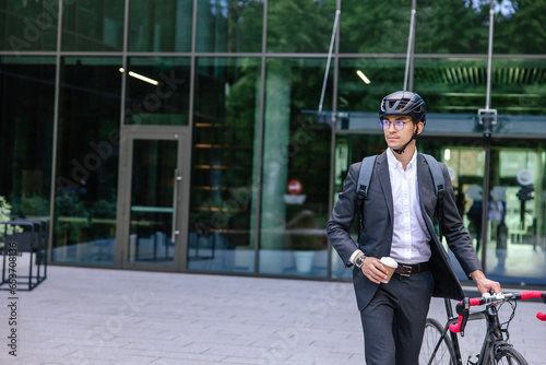 Elegant businessman in hemlet with electric scooter photo