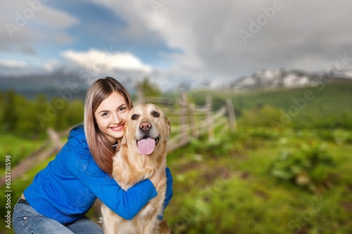 a young happy woman plays with a dog