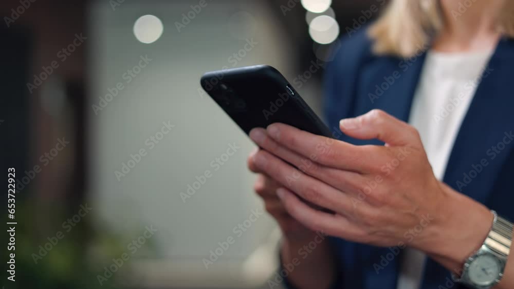 Close up of businesswoman arms with silver stylish watch holding personal smartphone in business cente. Beautiful female dressed in formal office clothes scrolling and tapping on mobile screen. Close up of businesswoman arms with silver stylish watch holding personal smartphone in business cente. Beautiful female dressed in formal office clothes scrolling and tapping on mobile screen.