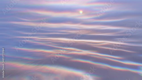 Blurred water slowly moving. Ripples with chromatic aberration and glistening reflections.