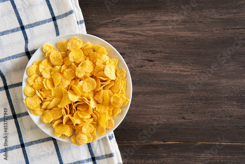 Corn flakes served on wooden table.