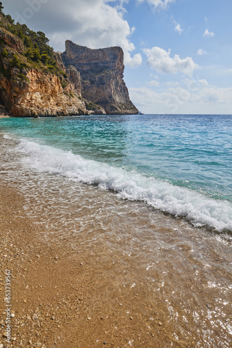 Fototapeta Naklejka Na Ścianę i Meble -  Beautiful beach in a bay with cliffs, blue skies and azure Mediterranean Sea.Cala del Moraig beach in Benitatxell of Alicante, Costa Blanca, Spain.