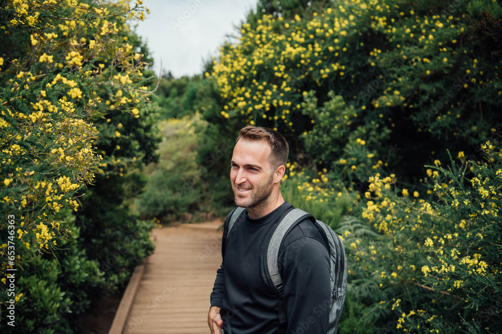 Portrait of a young hiker smiling in the forest