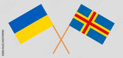 Crossed flags of Ukraine and Region of Aland. Official colors. Correct proportion photo