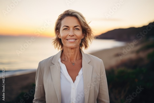 Beautiful gorgeous mature 50s mid age beautiful elderly senior model woman smiling in a sunset beach. Close up portrait. Healthy face skin care beauty, skincare cosmetics, dental, mental health, relax photo