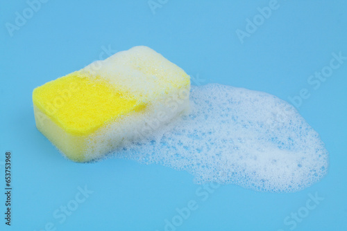 Sponge with white foam on blue background.