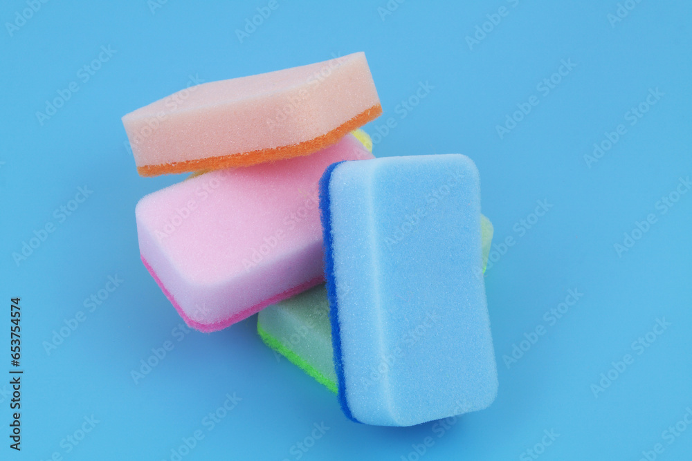 Obraz premium Five colorful sponges om blue background. 