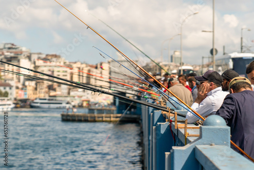 Photography Istanbul, Turkey - September 17, 2023: People fishing on Galata Bridge in Istanbul