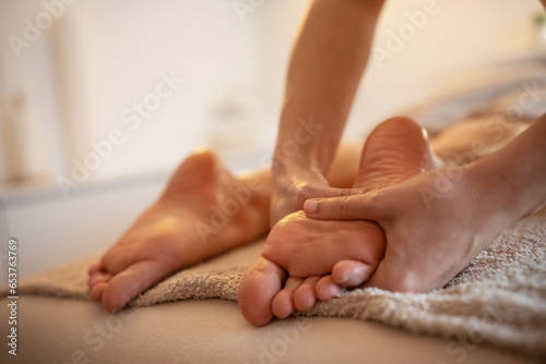 Skilled female masseur giving foot massage to young female.   © BalanceFormCreative