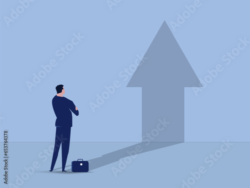 Businessman standing in front of wall and hist shadow is shaped as an arrow. The concept of personal development. vector illustration. photo