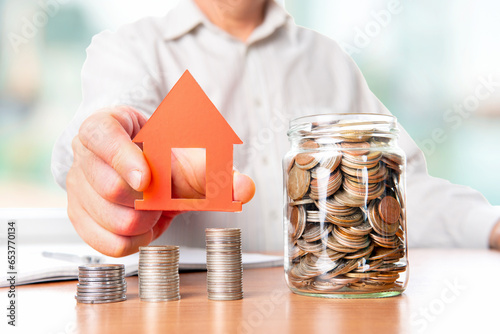 The coins are stored in a glass jar to accumulate finances.