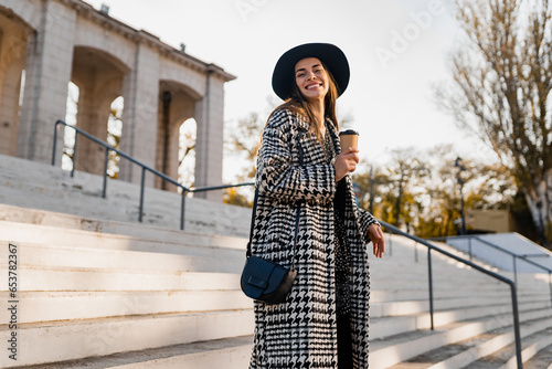 attractive young woman walking in autumn wearing coat