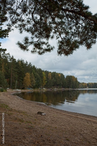 Lake shoreline with cloudy sky in late summer at lake Kuivajärvi, Liesjärvi National Park, Tammela, Finland. photo