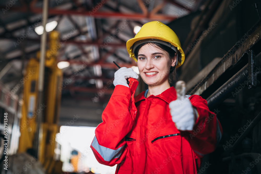 Portrait of Industrial engineers using walkie-talkie for check up machine at factory machines. Worker in the Manufacturing Industry in the train garage.. Portrait of Industrial engineers using walkie-talkie for check up machine at factory machines. Worker in the Manufacturing Industry in the train garage..