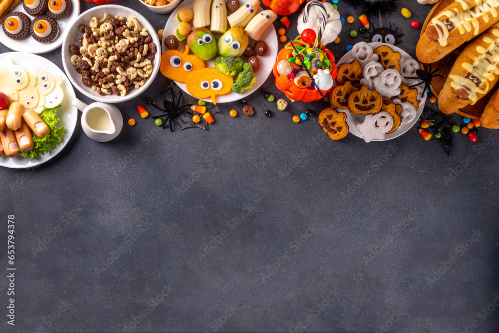 Halloween monster food and snack assortment. Set of funny creative food for children Halloween party, children brunch or breakfast - cookies, healthy and fast food snacks, breakfast cereals, hot dogs