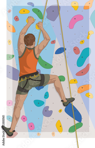sport climbing male climber scaling indoor artificial rock wall in background