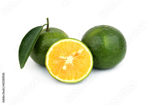 Green oranges with leaf isolated on white background.