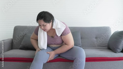 chubby asian woman feels pain from knee muscle injury after exercising