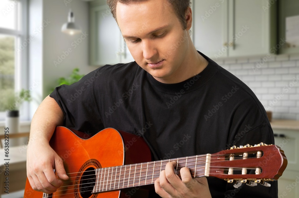 Obraz premium Cheerful young Student man Playing Guitar, AI generated image
