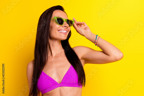 Photo of nice lovely person arm touch sunglass toothy smile empty space isolated on yellow color background