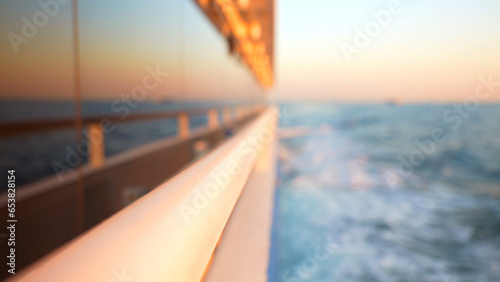 Blurred background with reflection of the sea in the floating yacht window at sunset © Bankerok