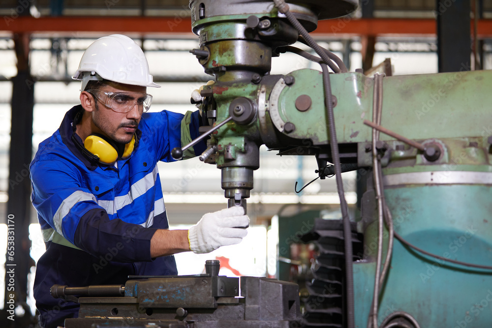 factory worker or technician checking and control lathe machine in factory factory worker or technician checking and control lathe machine in factory