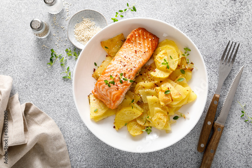 Salmon grilled and baked potato with onions, top down view