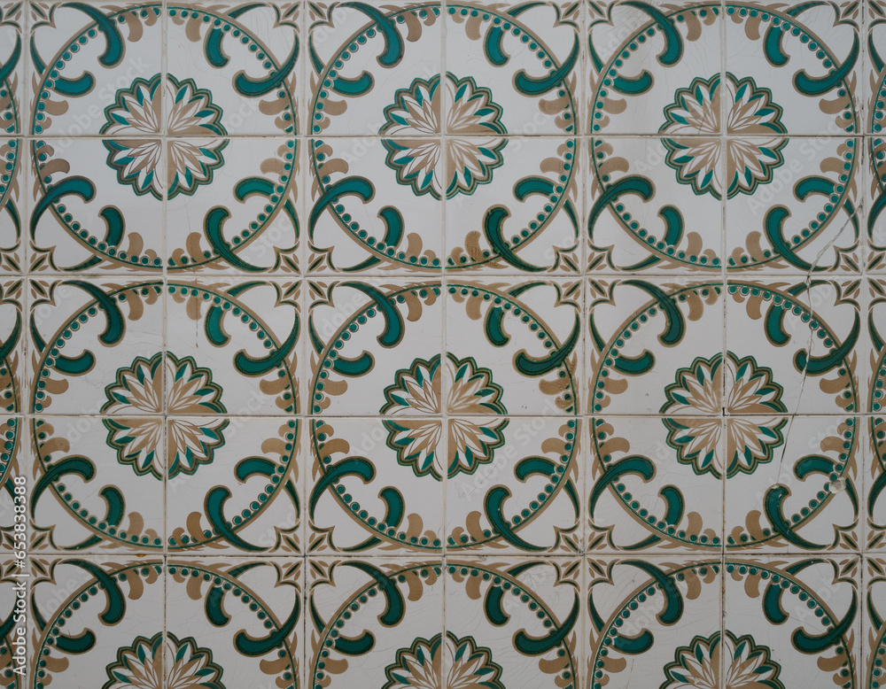 Part of a typical Portuguese wall decorated with tiles. Nice golden, green and white colors. Portugal. Horizontal photo.