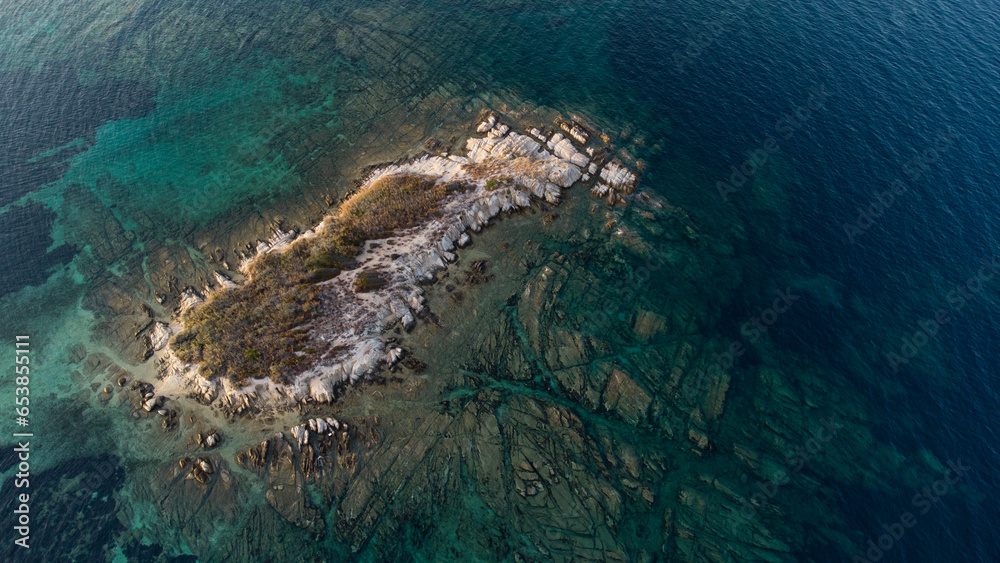 Aerial drone view of rocks, water and forest near the twin beaches of Karidi and small Karidi, Vourvourou, Sithonia peninsula, Halkidiki, North Greece