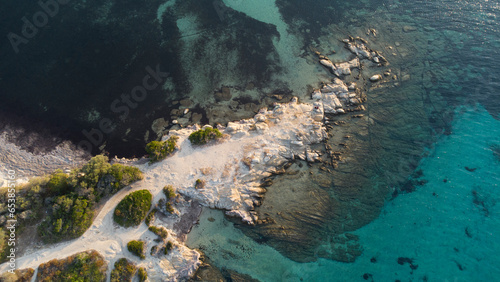 Aerial drone view of rocks, water and forest near the twin beaches of Karidi and small Karidi, Vourvourou, Sithonia peninsula, Halkidiki, North Greece