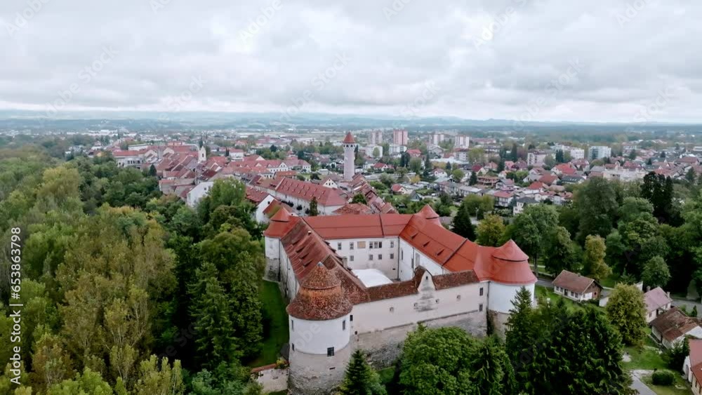 Aerial view of a historic Slovenian castle nestled amid lush greenery red roof Aerial view of a historic Slovenian castle nestled amid lush greenery red roof