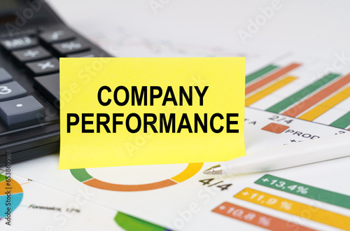 On business reports there is a calculator and a sign with the inscription - COMPANY PERFORMANCE