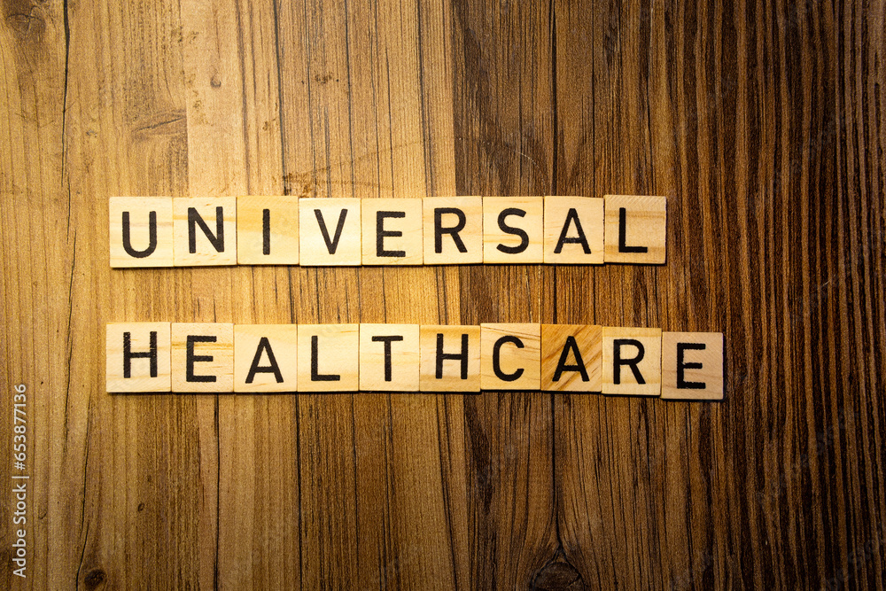 Universal Healthcare concept word in wooden letters on dark wood background Universal Healthcare concept word in wooden letters on dark wood background