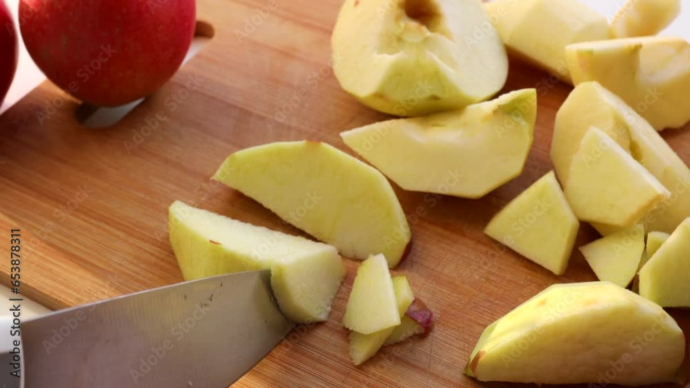 Cutting Red Apples with Knife on Wooden Chopping Board. Cutting Red Apples with Knife on Wooden Chopping Board.