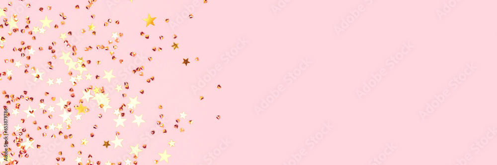 Banner with golden stars and crystals confetti on a pink pastel background. Festive concept. Selective focus.