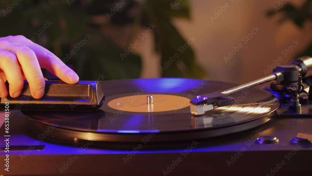 Man Cleaning retro vinyl with special brush - turntable vinyl record player, vintage record player, Sound technologies for DJ to mix and play music.