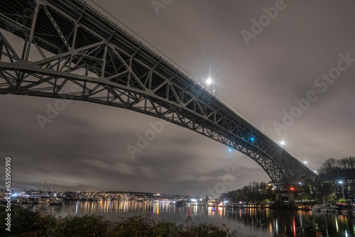 A rainy night view up Fremont Cut and across Lake Union to Eastlake, from under the Aurora Bridge in Seattle; Seattle, Washington, United States of America photo