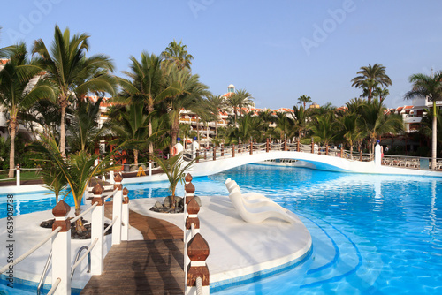 Hotel resort panorama with swimming pool and palm trees in Playa de las Americas, Tenerife photo