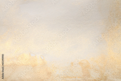 Watercolor paper grain texture painting wall. Abstract gold, nacre and beige marble copy space background. © Liliia