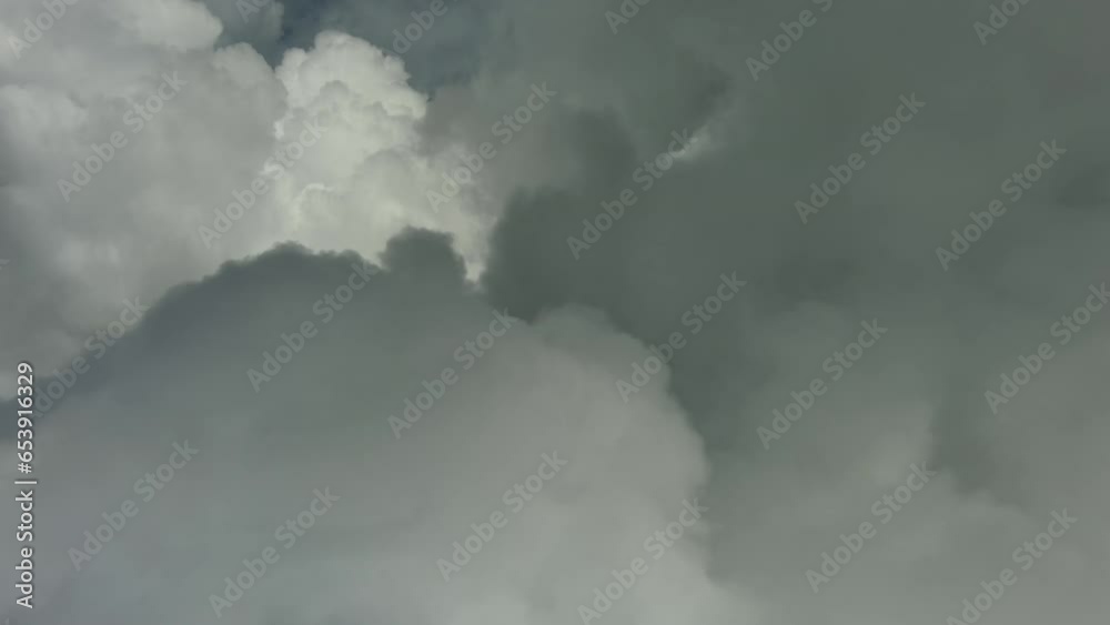 Flying through beautiful white fluffy clouds in blue sky. Airplane travel background, 4k