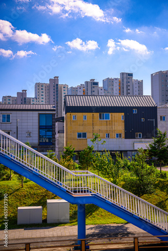 Abstract architectural geometry in the city. Suncheon City skyline with modern housing buildings under construction next to the highway bridge stairs in Jeollanam-do, South Korea.