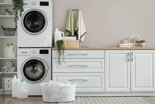 Laundry room with washing machines and white counters © Pixel-Shot