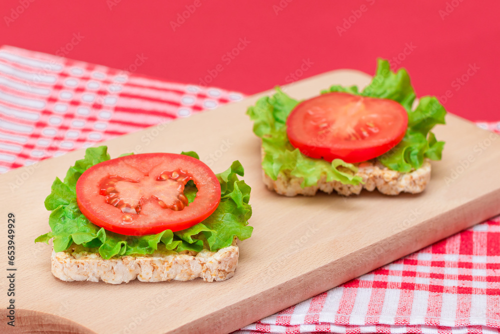Rice Cake Sandwiches with Tomato and Lettuce on Wooden Cutting Board. Easy Breakfast. Diet Food. Quick and Healthy Sandwiches. Crispbread with Tasty Filling. Healthy Dietary Snack Rice Cake Sandwiches with Tomato and Lettuce on Wooden Cutting Board. Easy Breakfast. Diet Food. Quick and Healthy Sandwiches. Crispbread with Tasty Filling. Healthy Dietary Snack