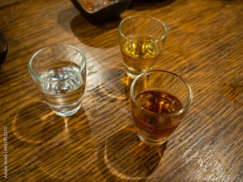 Three small glasses of exotic alcohol in a restaurant