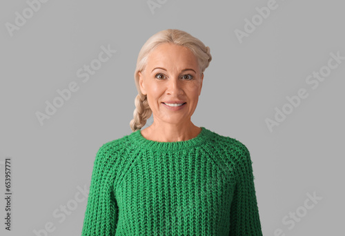 Mature woman on grey backgr...