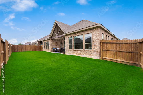 a back yard with a green lawn 