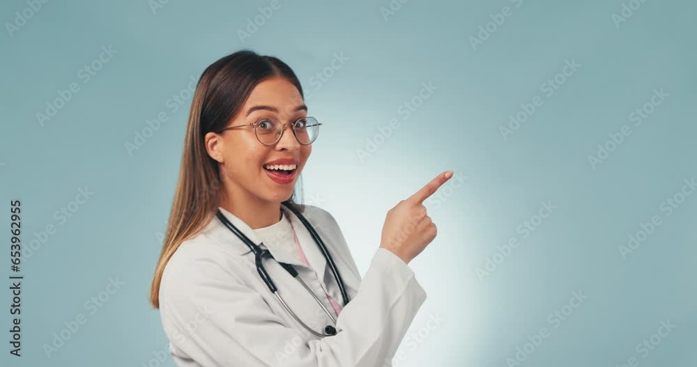 Portrait, studio and woman doctor pointing at advice for care, wellness or steps for health insurance. Medical professional in presentation for guide, information and smile on blue background mockup Portrait, studio and woman doctor pointing at advice for care, wellness or steps for health insurance. Medical professional in presentation for guide, information and smile on blue background mockup
