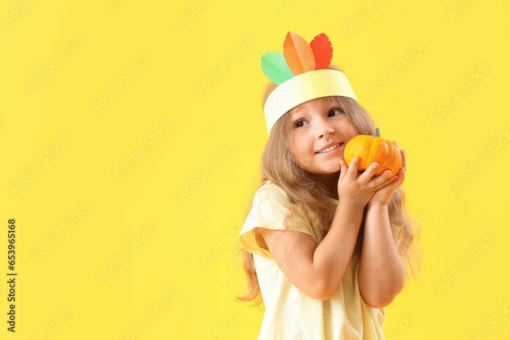Cute little girl with pumpkin on yellow background. Thanksgiving Day celebration Cute little girl with pumpkin on yellow background. Thanksgiving Day celebration