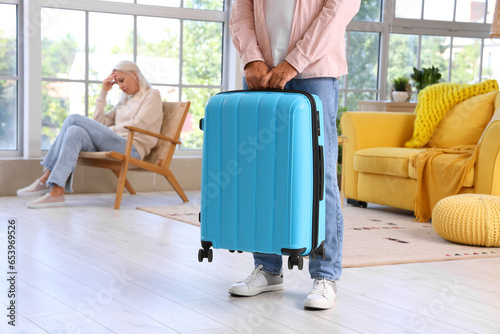 Mature man with suitcase le...